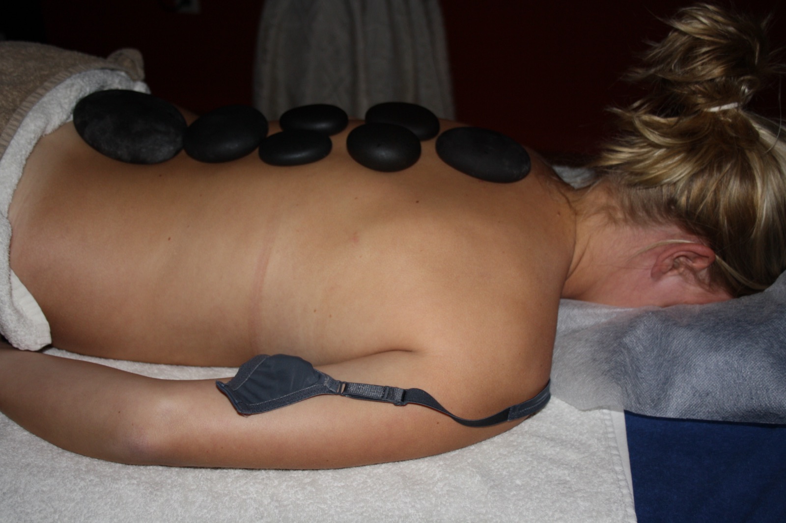 Hot stone massage met warme basaltstenen op de rug